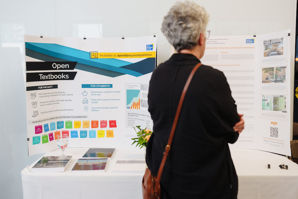 A person standing in front of a presentation poster