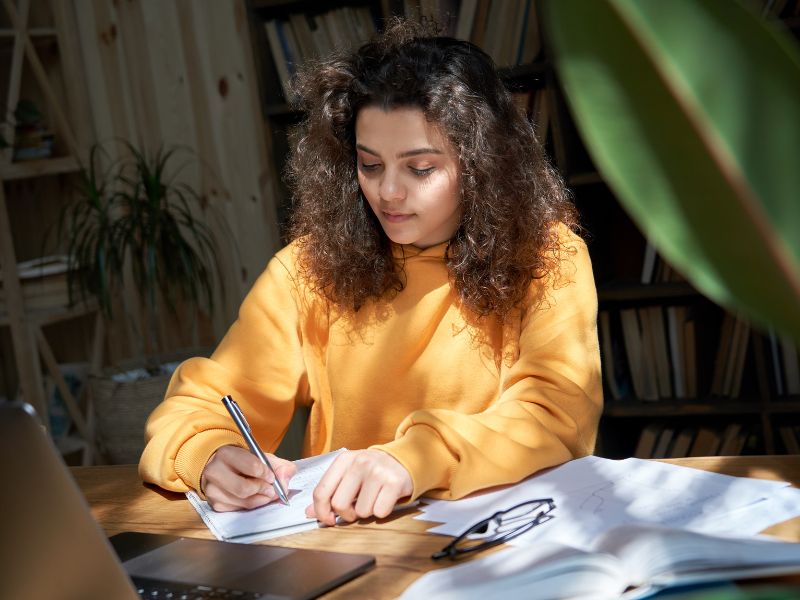 A student working on an assignment at a desk.