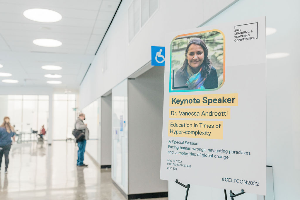 A wayfinding sign with a photo of Dr. Vanessa Andreotti