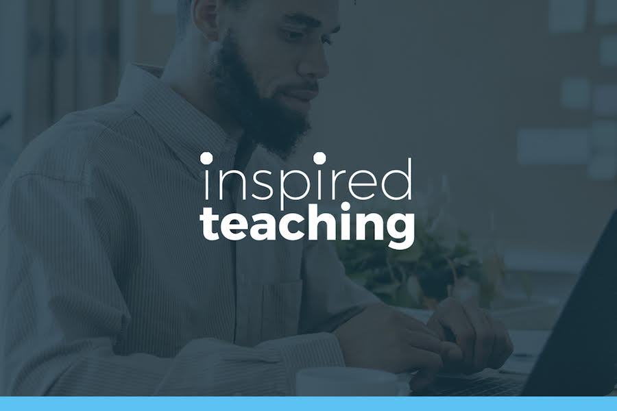 Caucasian male professor engaging with diverse group of students in a classroom