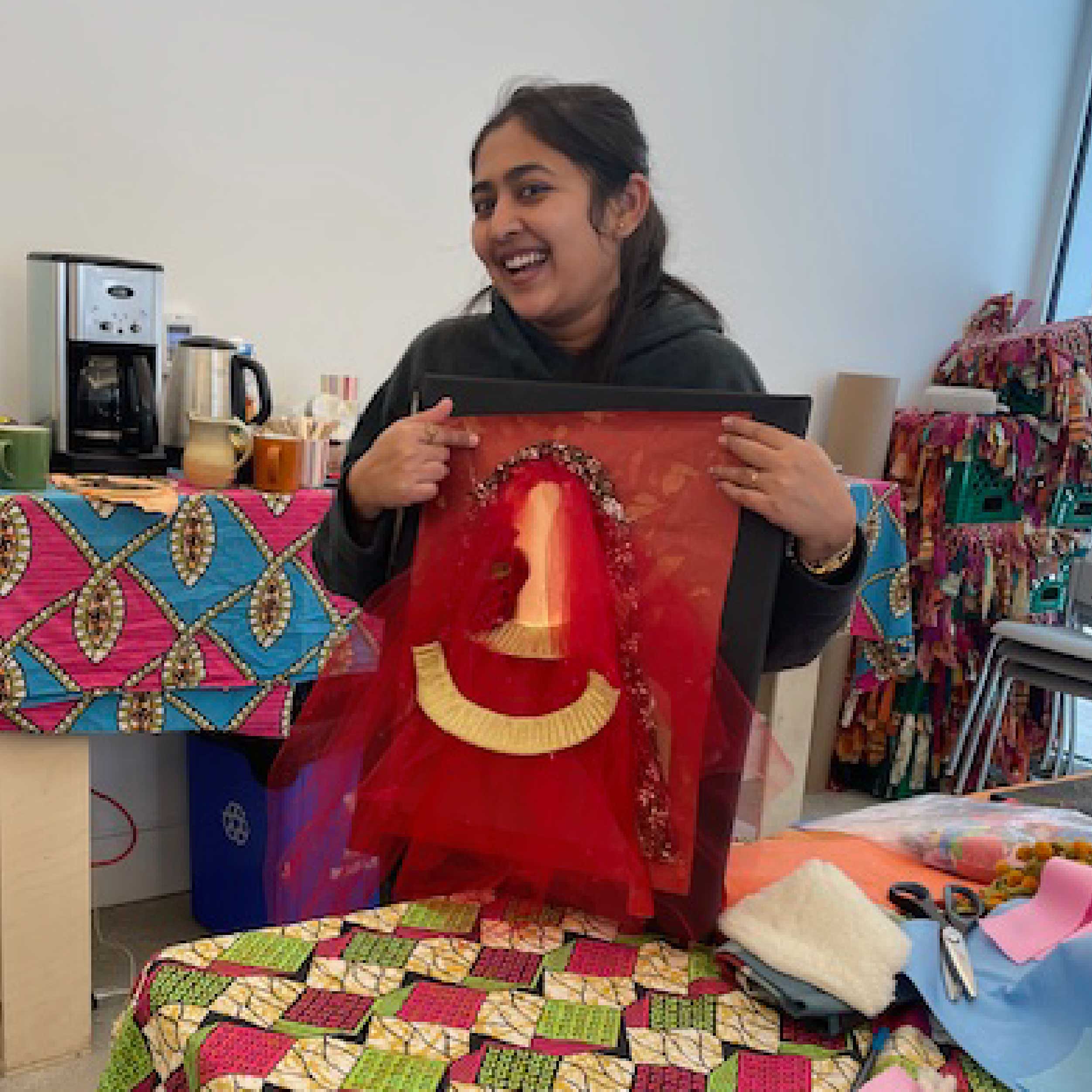 Mabelle Arts participant holding their craft