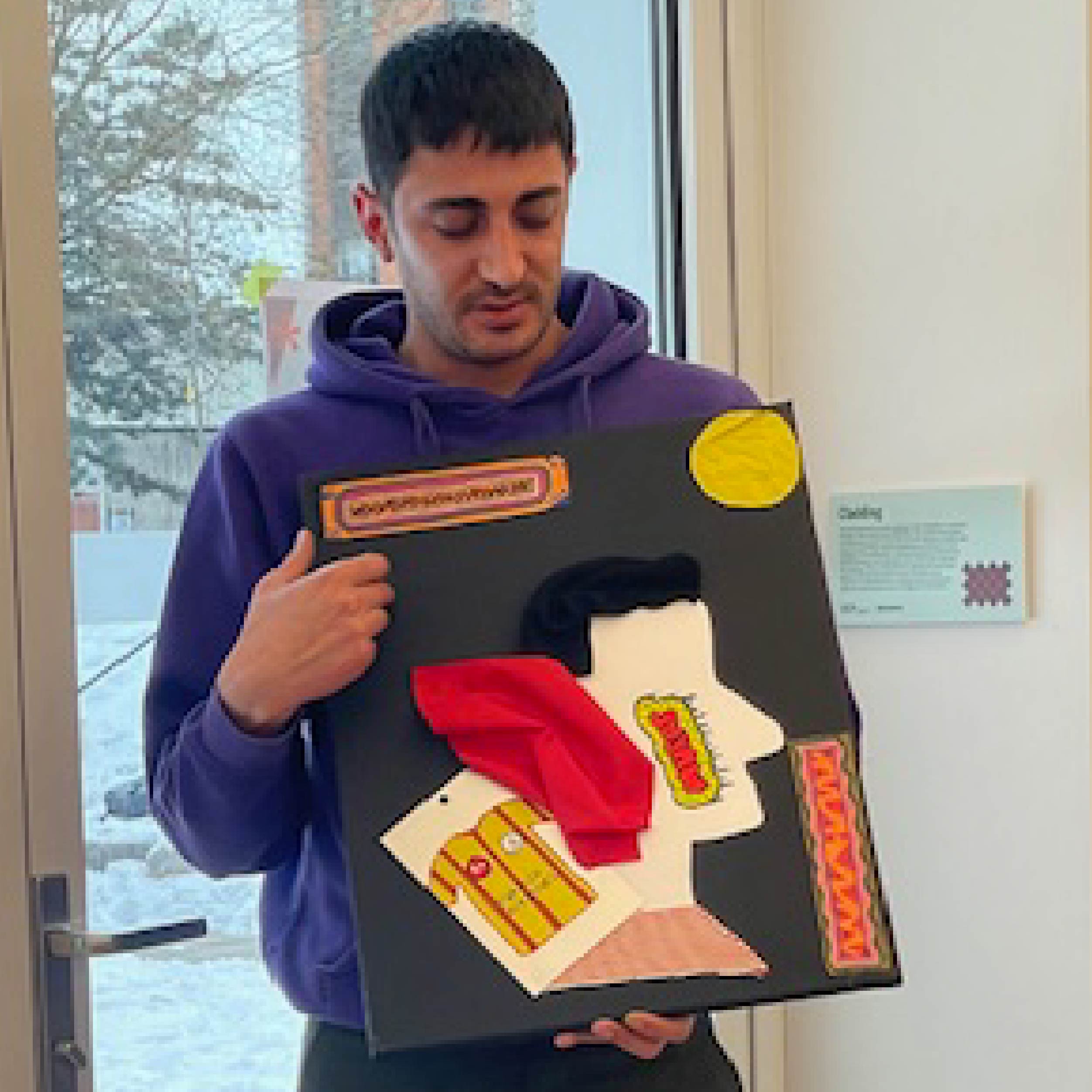 Mabelle Arts participant holding their craft