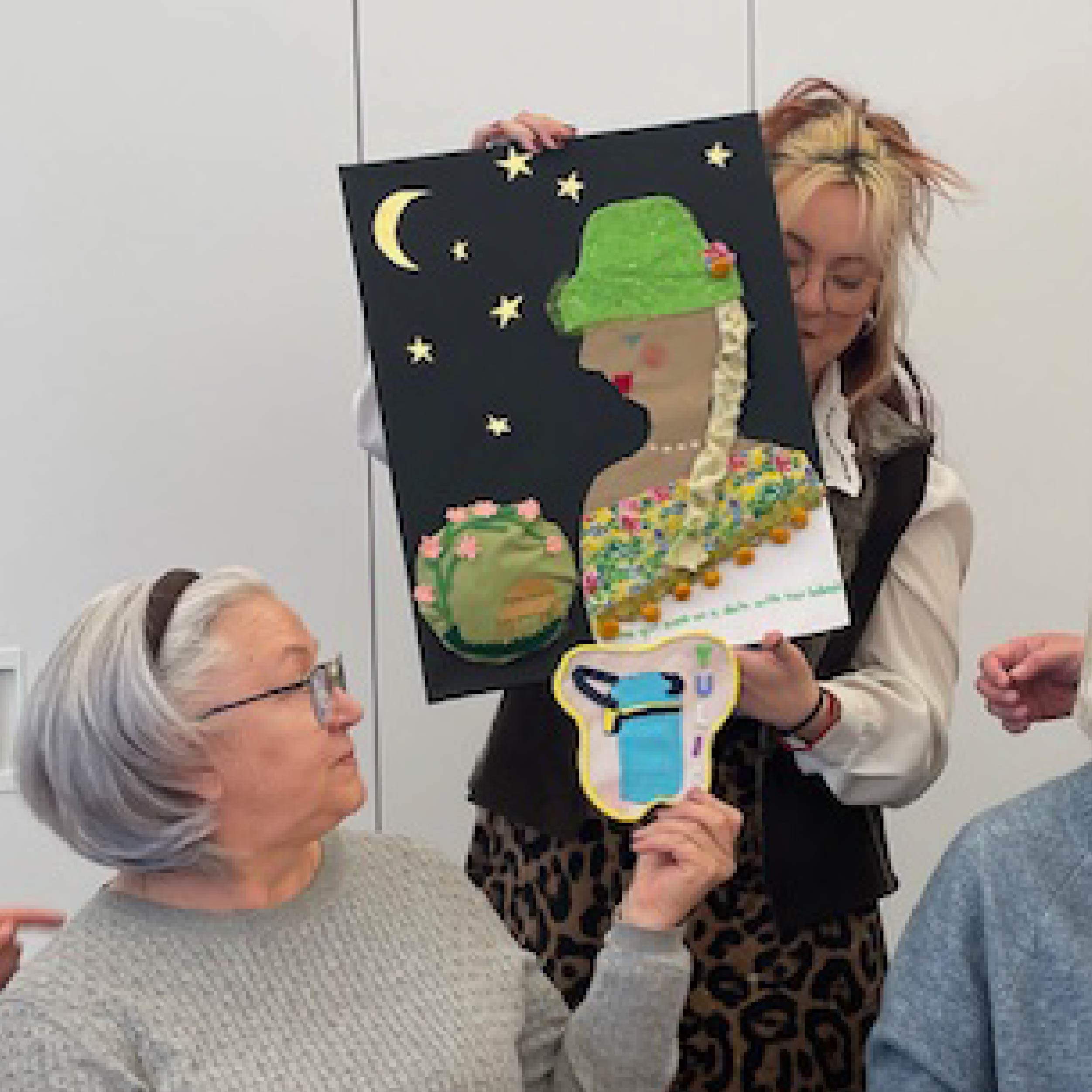 Mabelle Arts participant holding their craft