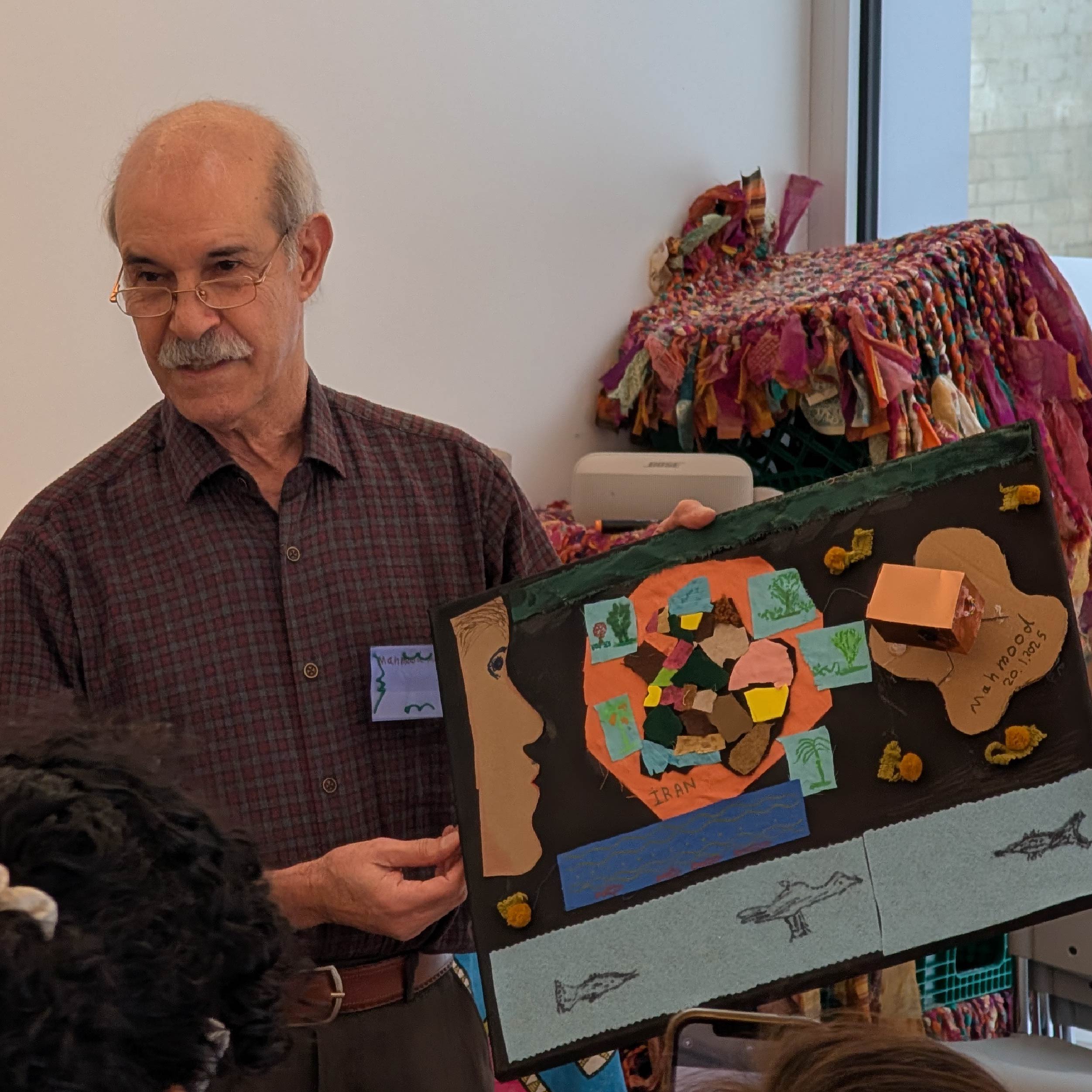 Mabelle Arts participant holding their craft