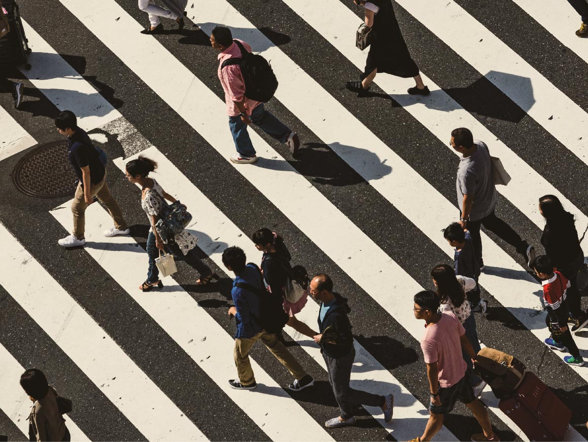 People walking across a crosswalk