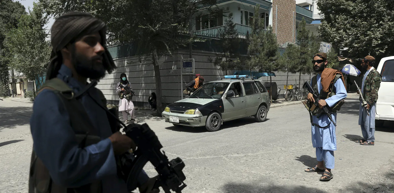 Taliban fighters stand guard at a checkpoint in Kabul, Afghanistan, on Aug. 18, 2021