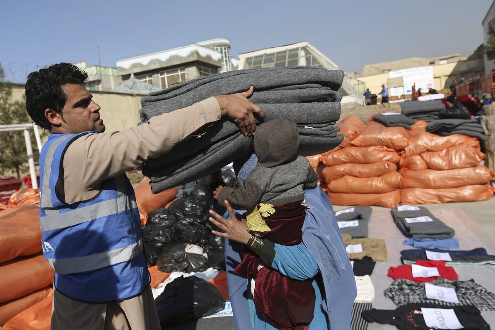 An Afghan internally displaced refugee receives winter necessities from the UNHCR in 2017