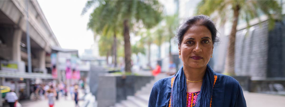 Landscape photo of south asian women looking at camera 