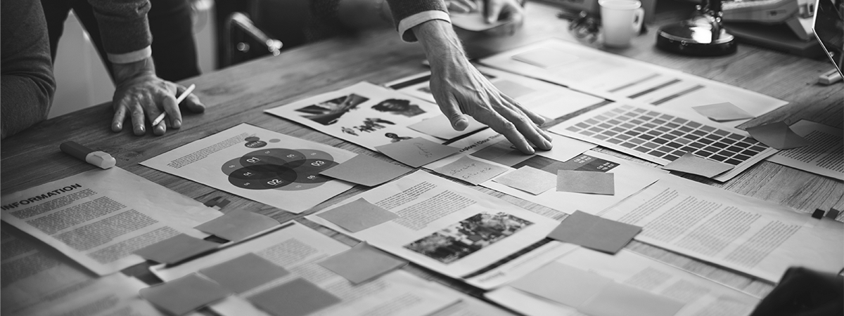 Image of people collaborating with papers on a table