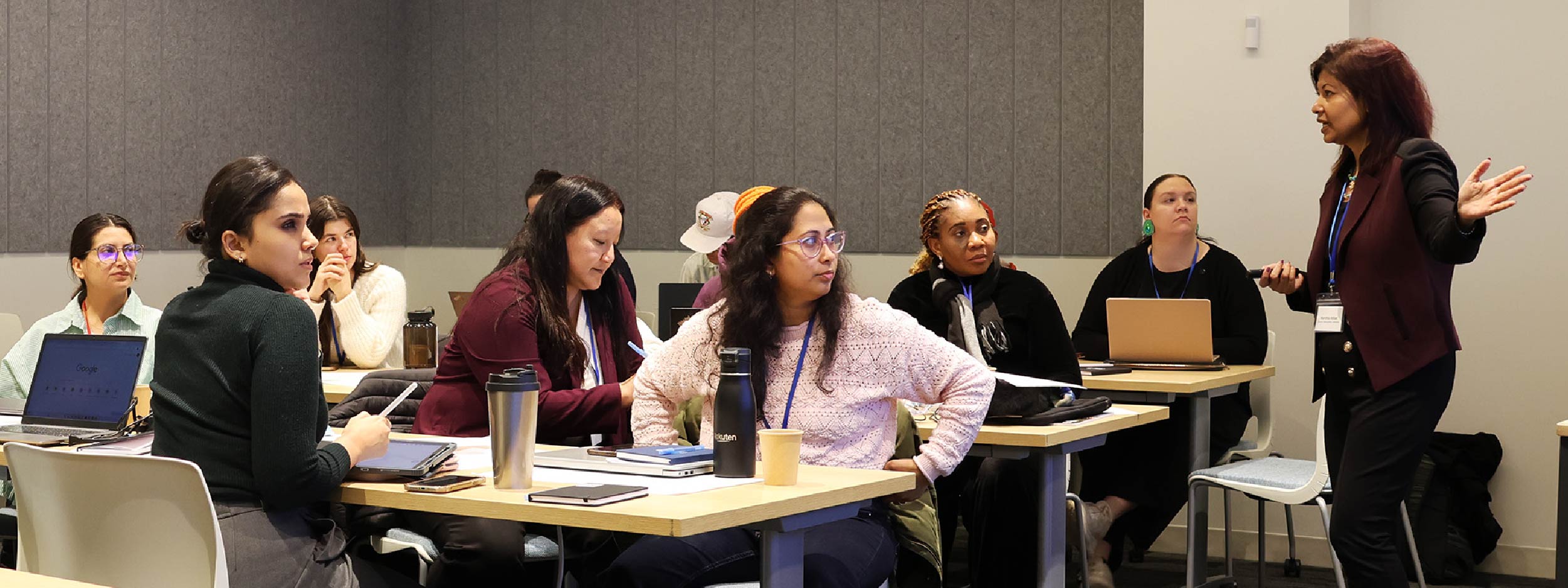 Winter School participants sitting in a conference room with Dr. Marshia Akbar instructing