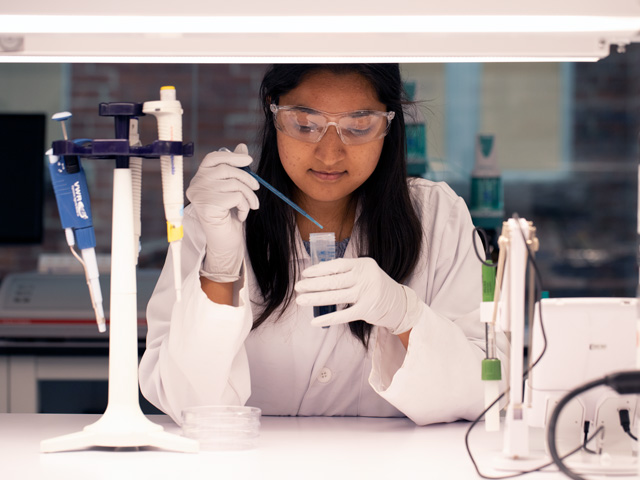 Chemistry and Biology student working on food chemistry in lab.