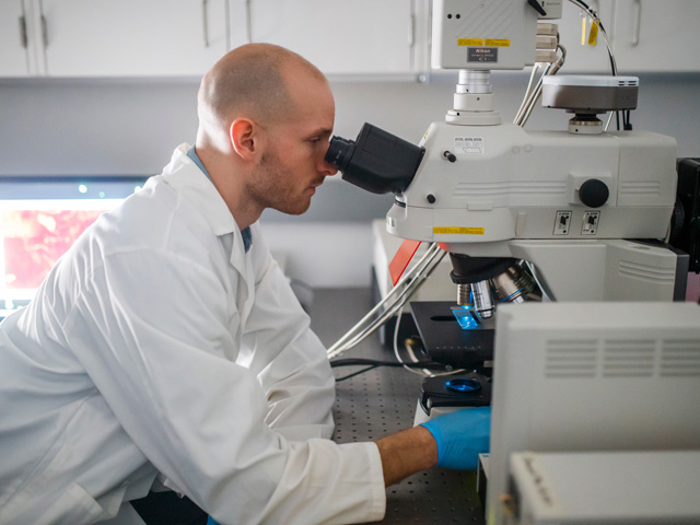 Chemistry and Biology student working on surface research in lab.