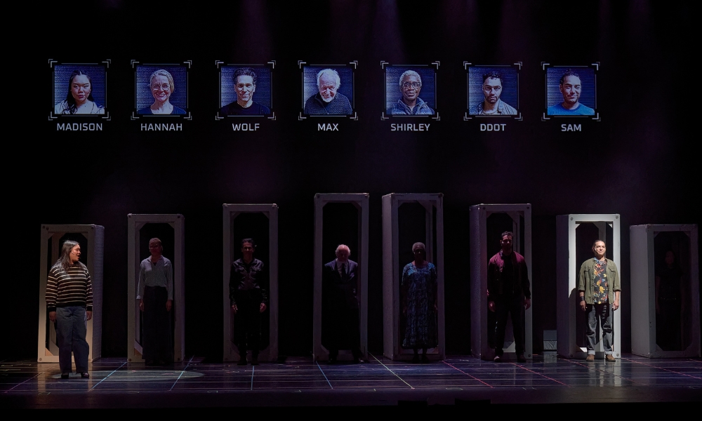 A wide shot of the stage with 7 actors, each standing in their own doorway with digital portraits and names above them. The female actor on the left and the male actor on the right are stepping forward and spotlit.