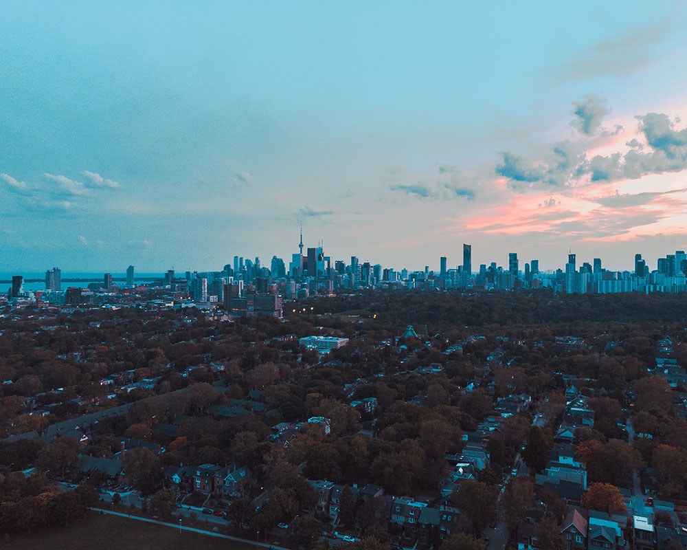 Aerial photo of Toronto looking downtown over a large area of detached residential housing.
