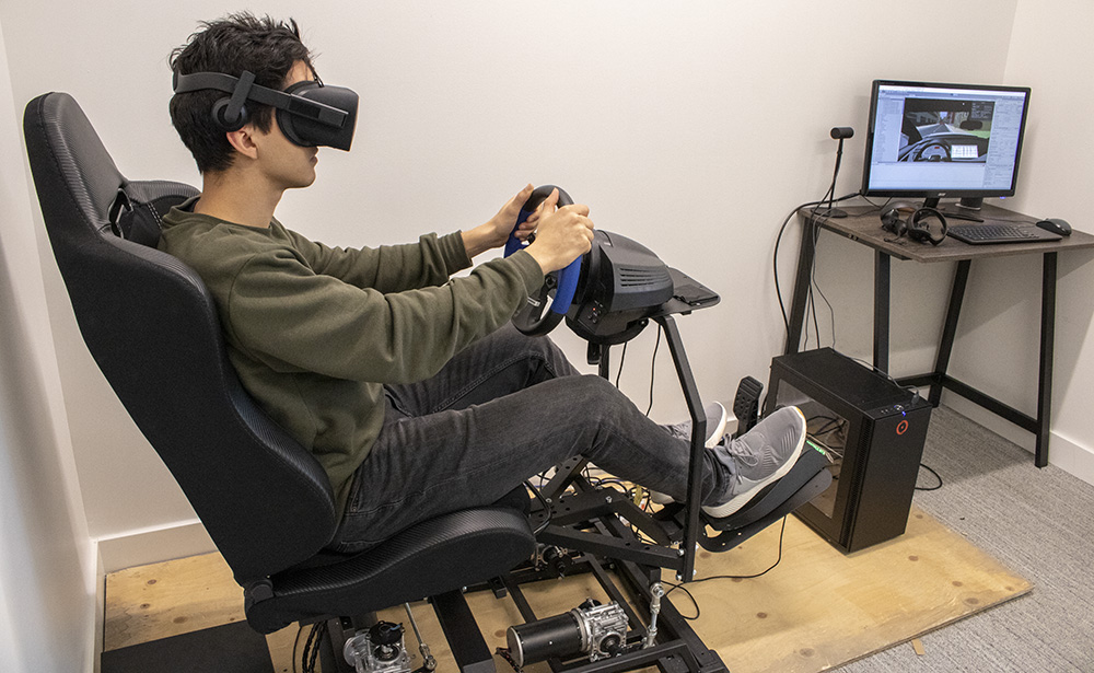 Graduate student in a chair using VR at the laboratory of innovations in transportation