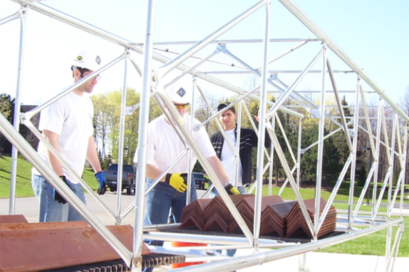 Civil engineering students building a steel bridge as part of a competition