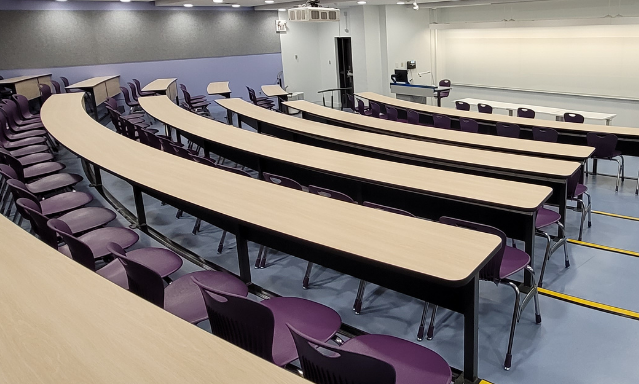 A refreshed, tiered classroom with new desks and chairs, acoustic panels and paint