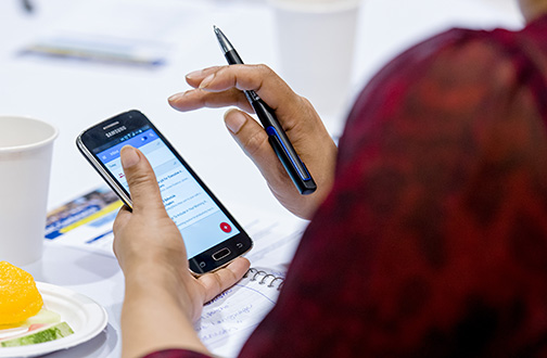 Close up of someone making a call on their mobile phone.