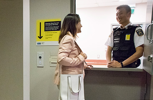 Community member talking to a member of Ryerson Security at the new Victoria Street location.