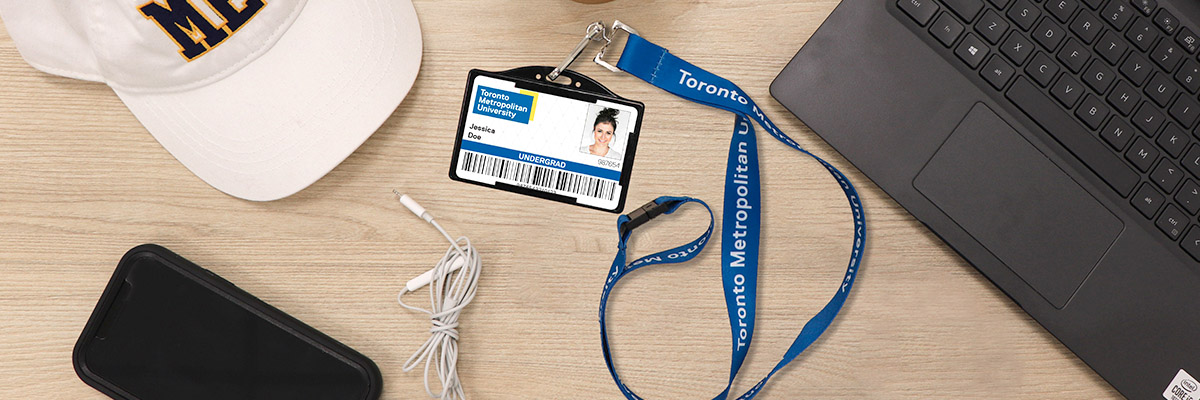 A OneCard on a TMU lanyard on a desk.