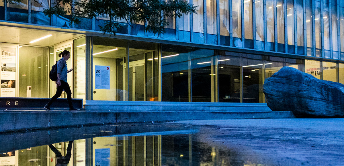 Person walking alone on campus.