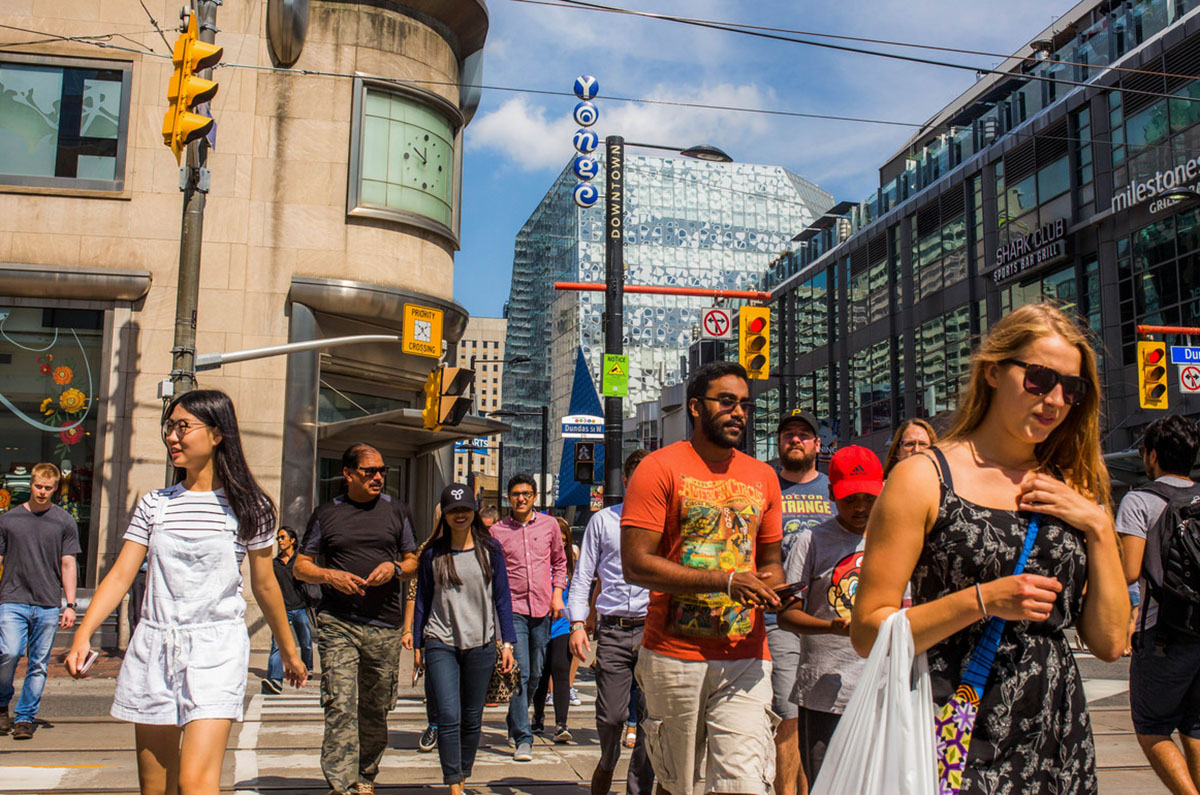 People walking through the intersection at Yonge and Dundas in Toronto
