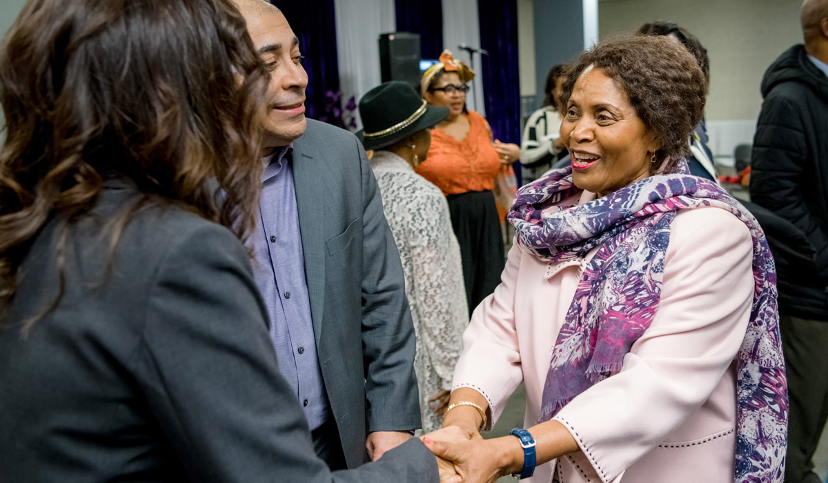 Pamela Appelt shaking hands with other attendees at the Viola Desmond Awards. 