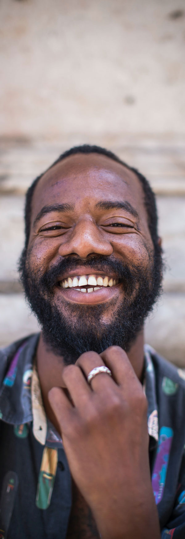 Black man with a beard smiling.  