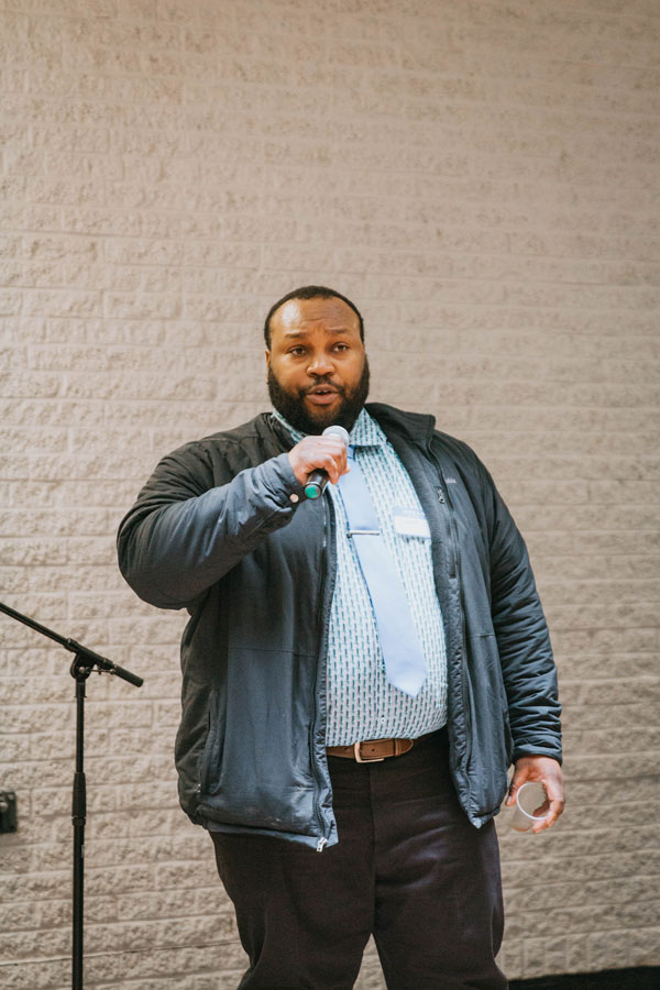 Black staff, Lance Campbell, speaking on the microphone.