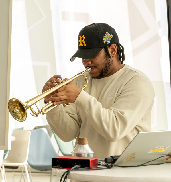 The Chmst playing the trumpet at the Black Excellence Mixer. 