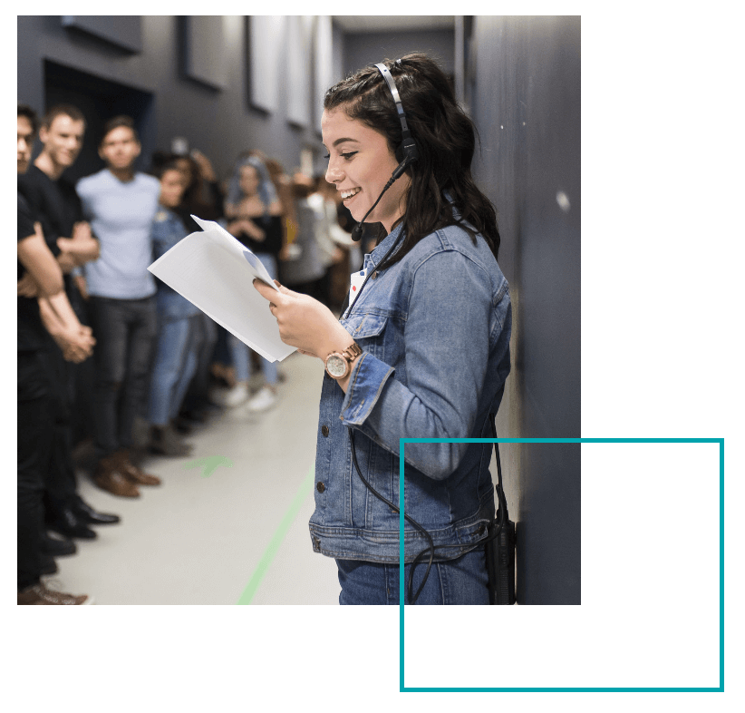 TMU student with headset backstage at a student fashion show production