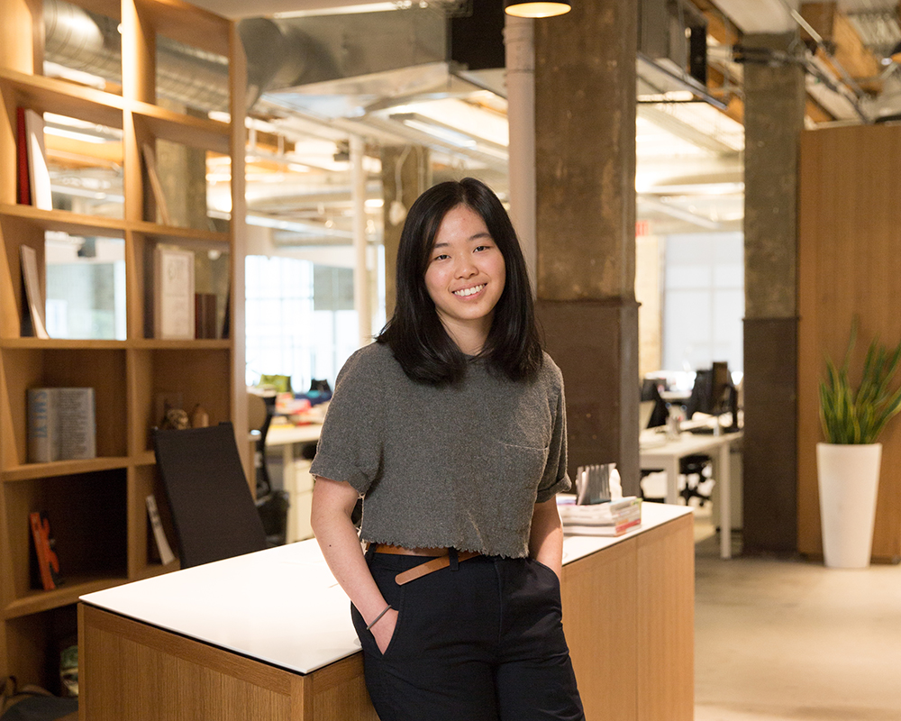 A student posing at the site of their internship.