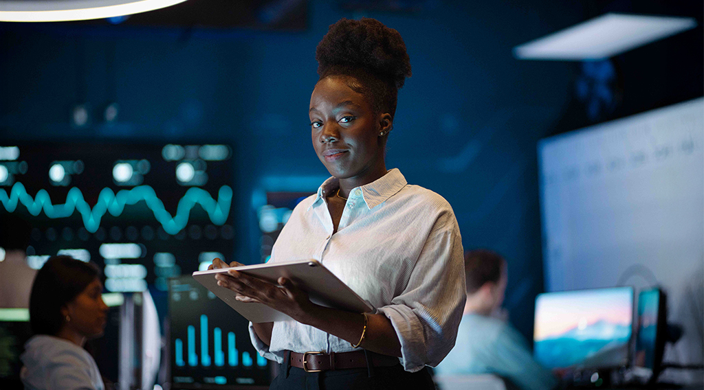 Student holding a tablet in a situation room