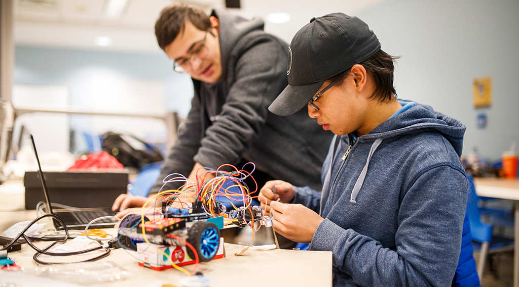 Two students collaborating on a robotics project