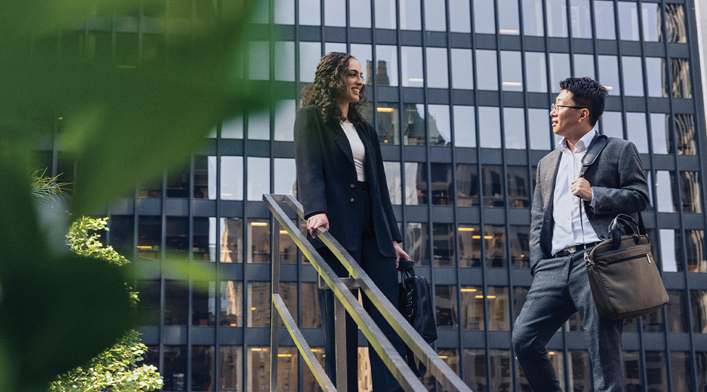 Coop student speaking to colleague outside an office building