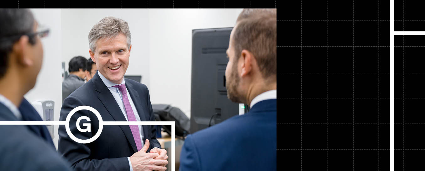 Rod Philips speaking two other people at an event.