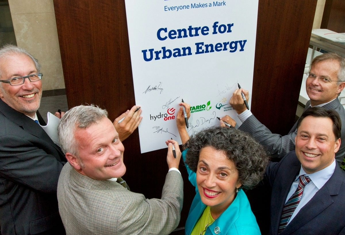 Individuals from partnership companies signing the Centre for Urban Energy opening certificate