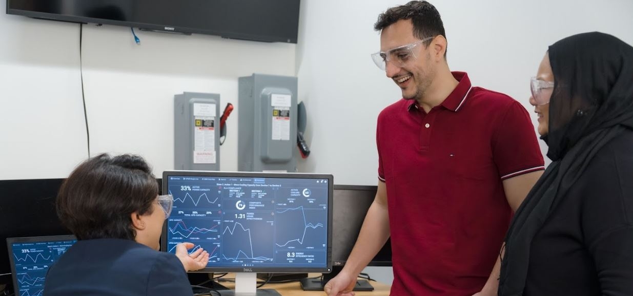 3 Researchers in the lab, looking at graphs together