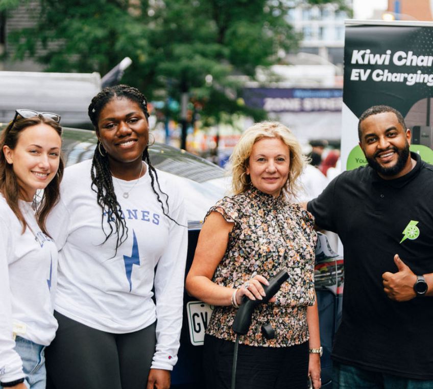 Kiwi Charge group picture with project behind them