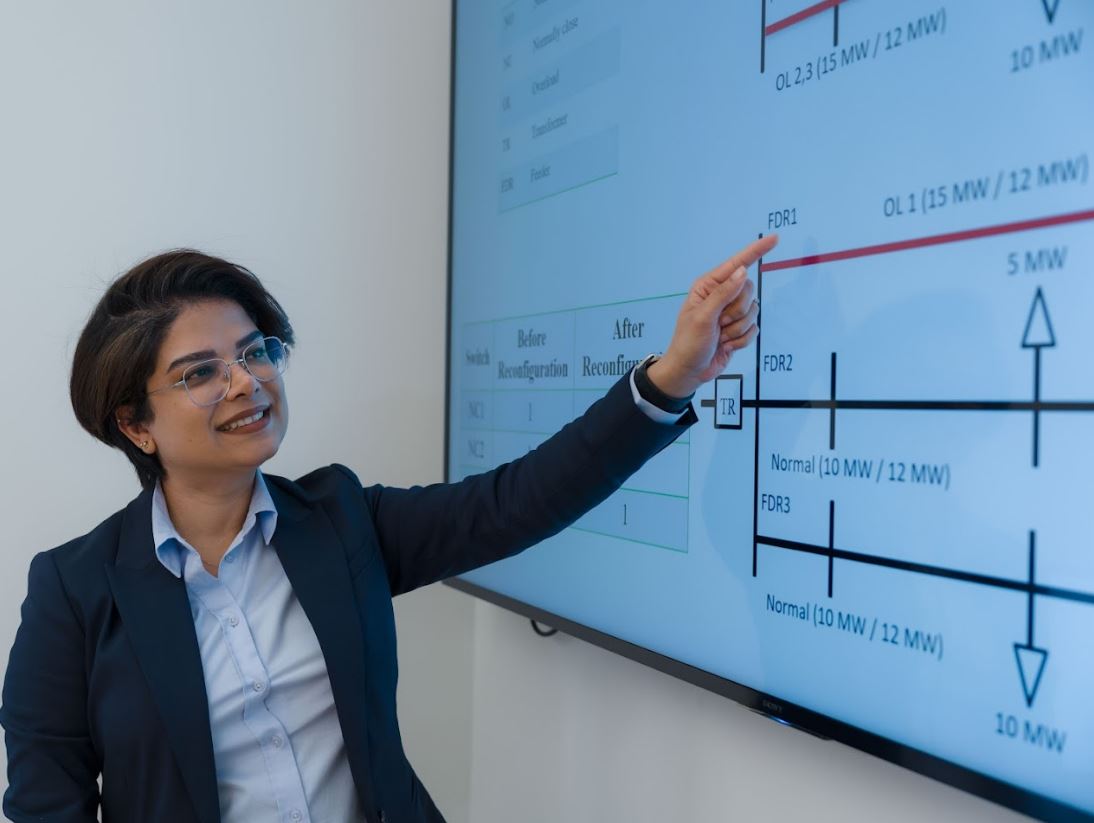 research fellow pointing at screen at FDR1 of the project