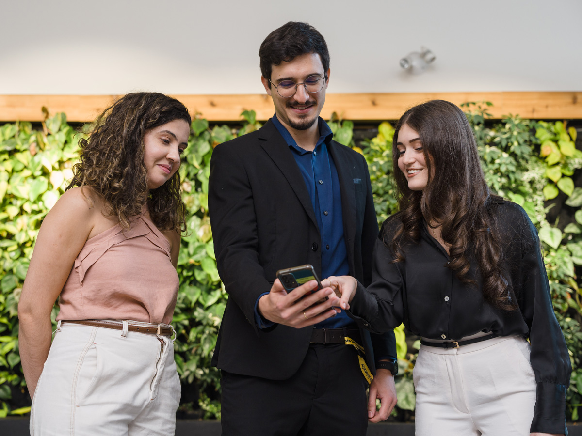 2 researchers looking at laptop together smiling