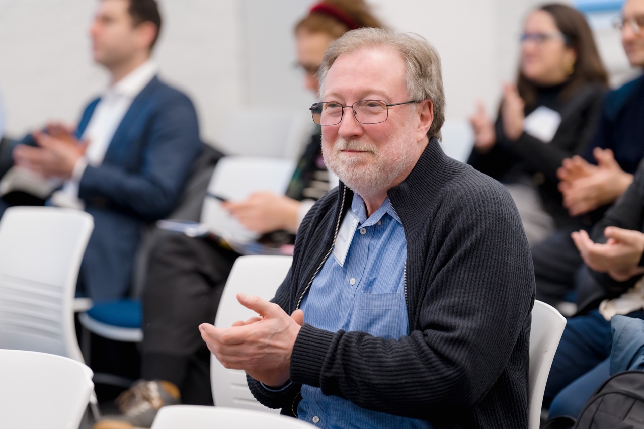 Guests applauding a speaker