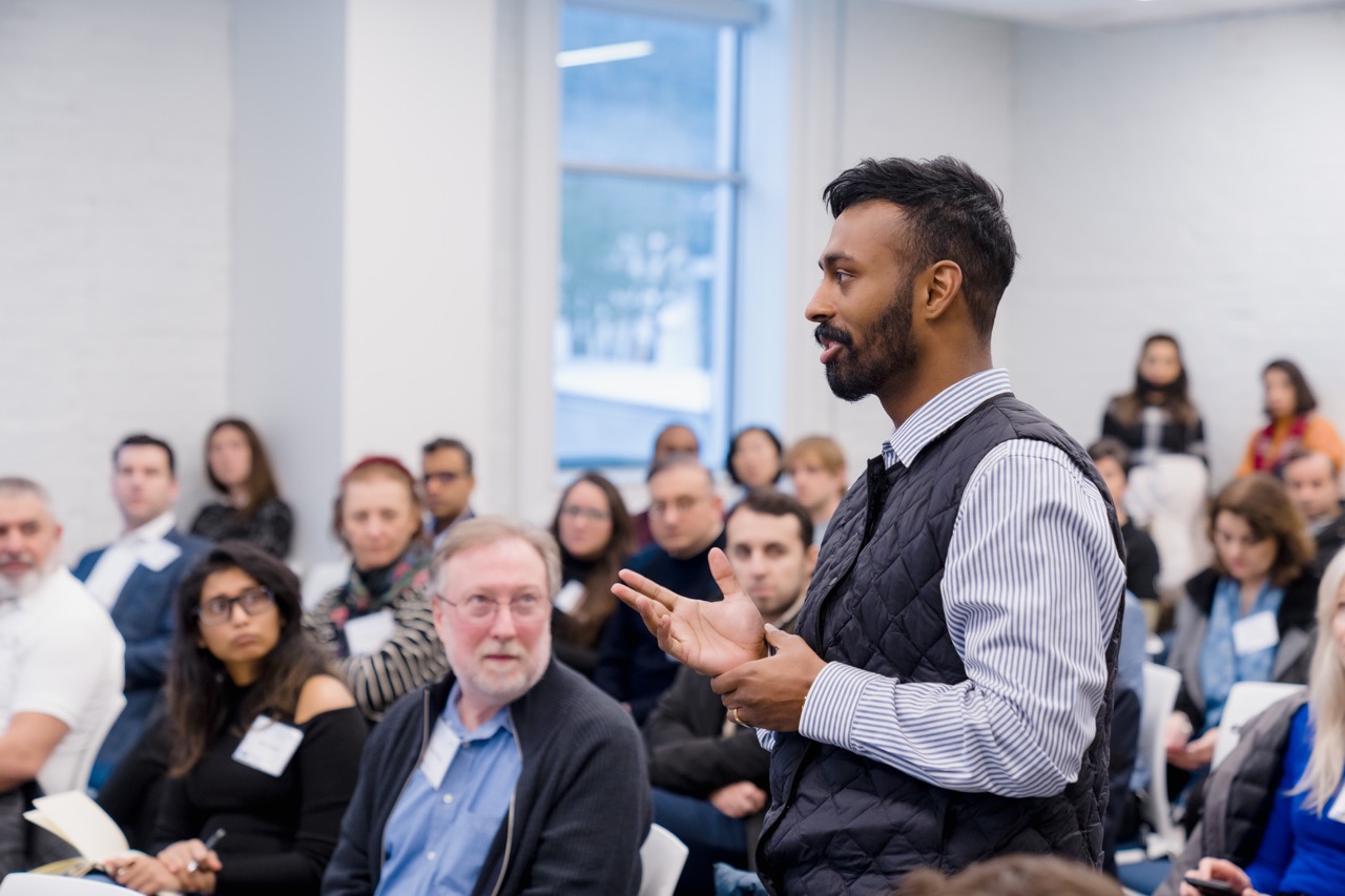 Interested guests paying attention to a participant that is asking a question
