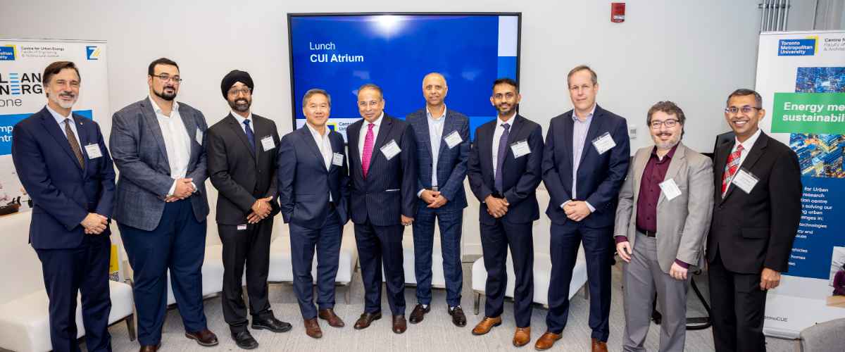 ETW group posing in front of a screen