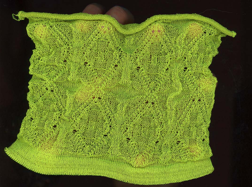 Neon green threads precisely knit into a decorative pattern. 