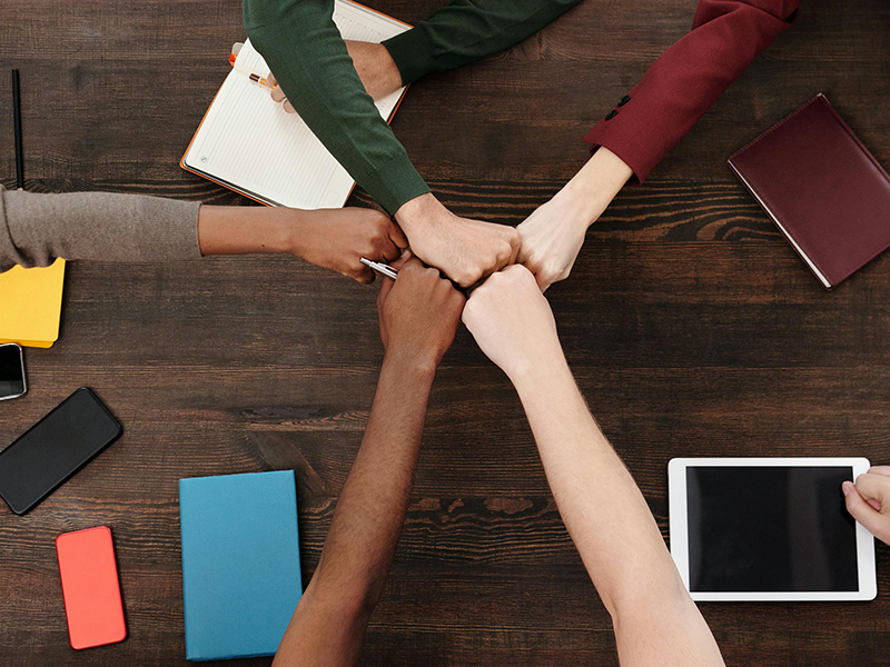 A team bumping fists in celebration