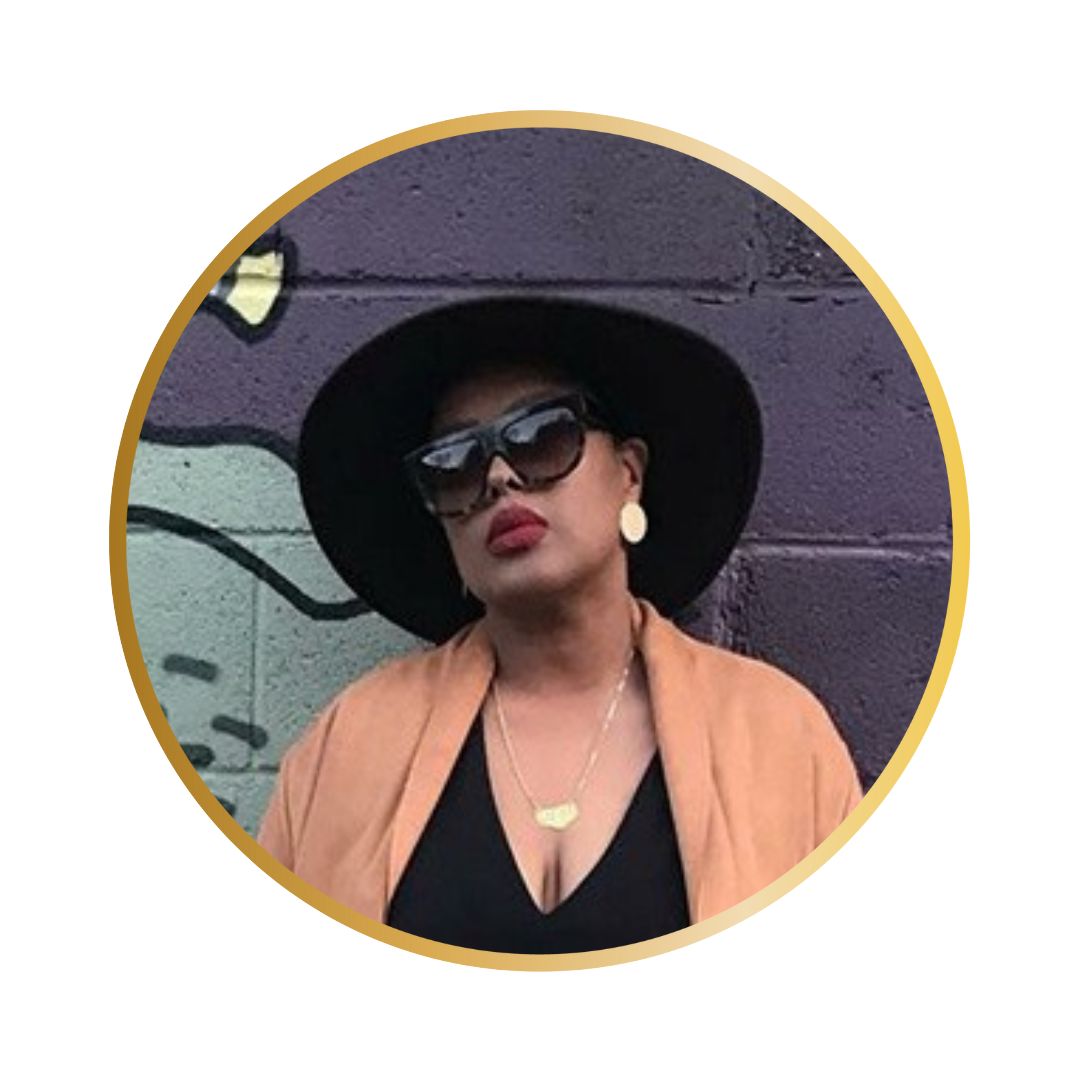 A photo of a Black woman wearing a large black hat and sunglasses