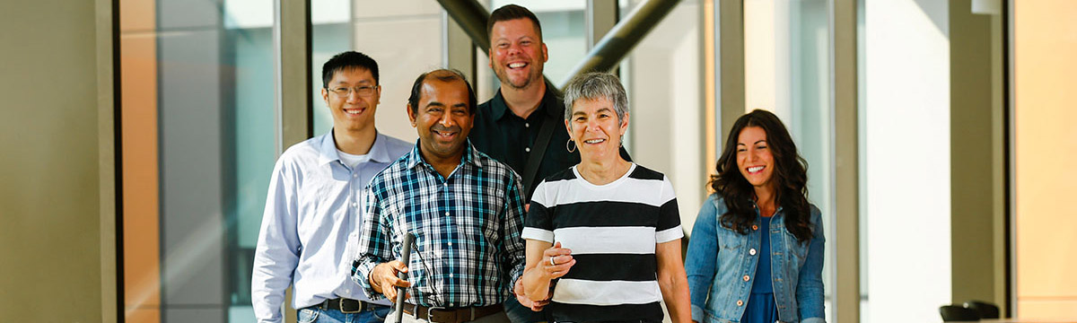 A group of TMU employees walking down hallway