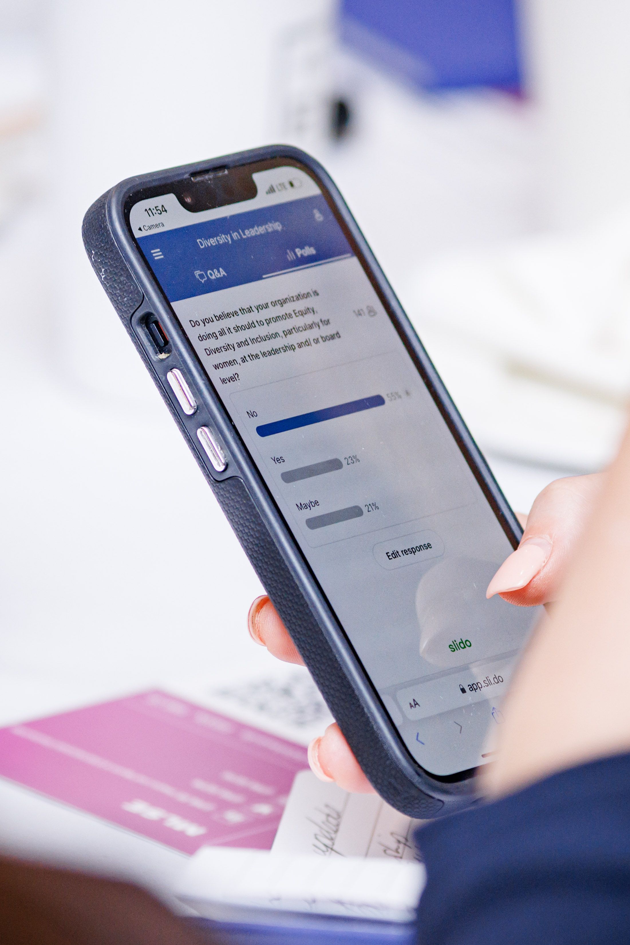 A smartphone application allows attendees to participate in the live poll. 