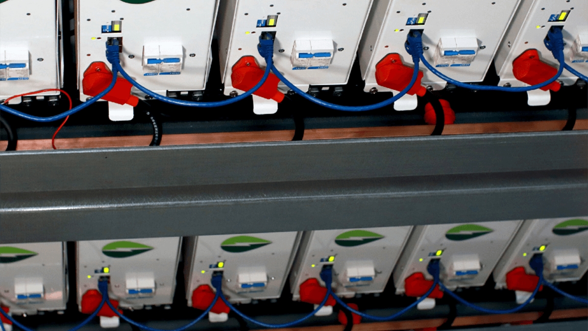 Rows of Grengine's energy storage solution technology connected by blue wires.